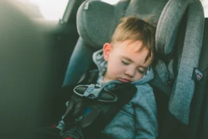 child sleeping in carseat